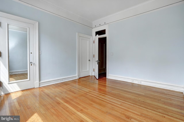 spare room with light hardwood / wood-style flooring and ornamental molding