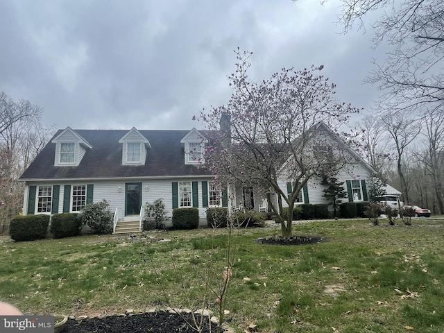 new england style home with a front lawn