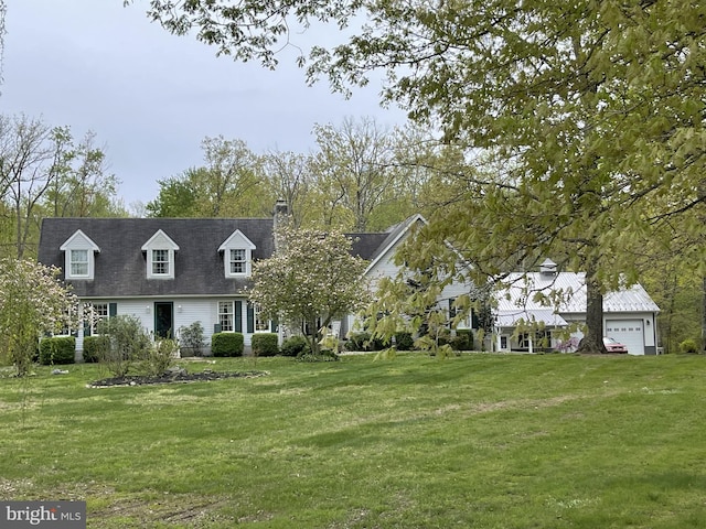 view of front of home with a garage and a front lawn