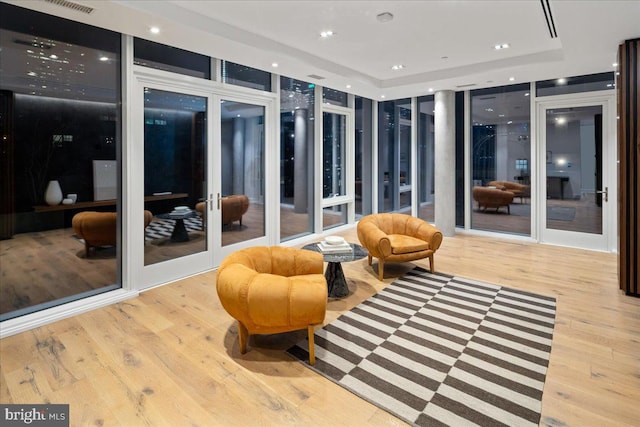 sunroom featuring french doors and a tray ceiling