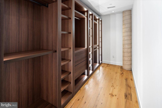 walk in closet featuring light hardwood / wood-style flooring