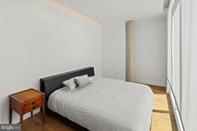 bedroom with wood-type flooring