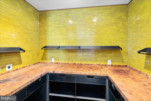 interior space with tasteful backsplash and wooden counters