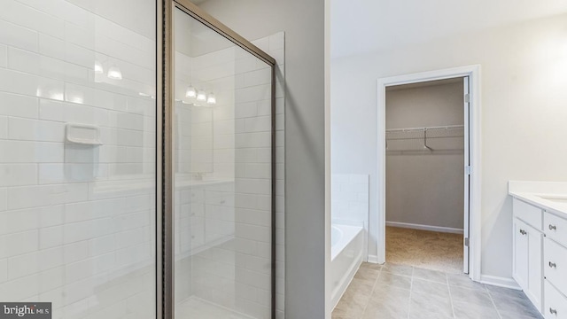 bathroom featuring tile patterned floors, vanity, and plus walk in shower