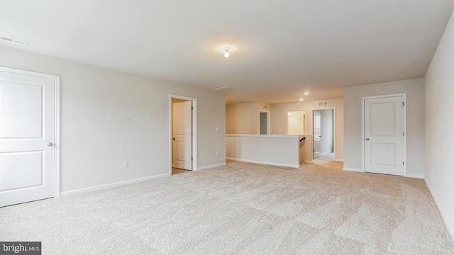 unfurnished living room with light colored carpet