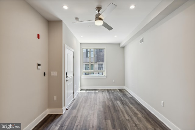 spare room featuring dark hardwood / wood-style floors and ceiling fan