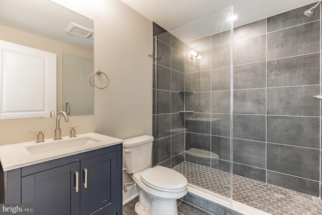 bathroom with an enclosed shower, toilet, tile floors, and vanity