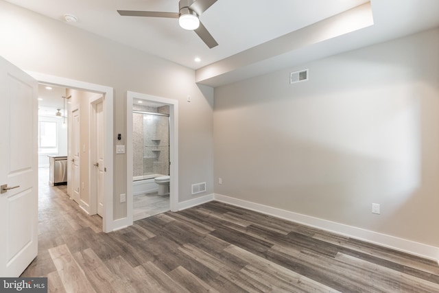 empty room with ceiling fan and dark wood-type flooring