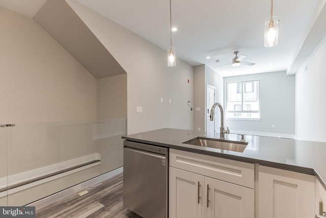 kitchen with ceiling fan, sink, stainless steel dishwasher, hanging light fixtures, and hardwood / wood-style floors