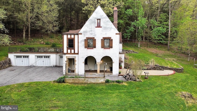 view of front of property with a patio area and a front lawn