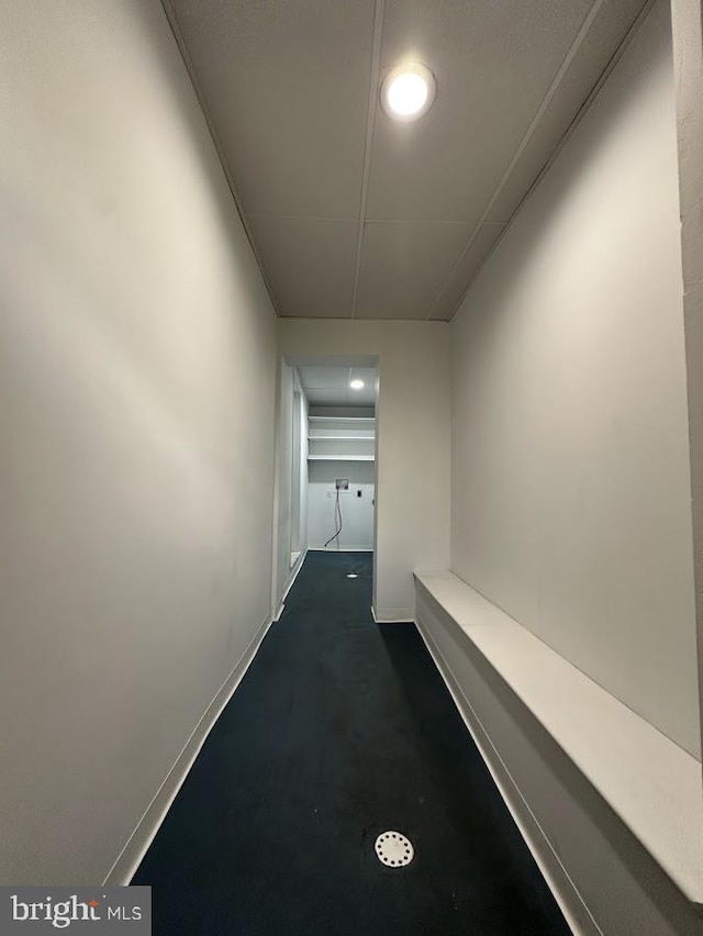 corridor featuring dark carpet