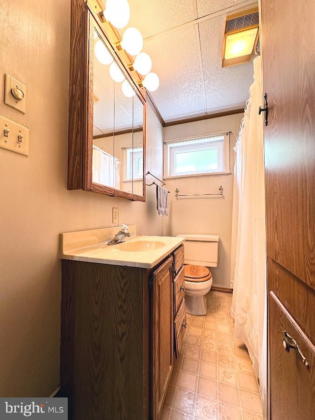 bathroom with tile floors, a paneled ceiling, vanity, and toilet