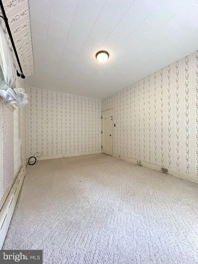 bonus room with carpet and a baseboard heating unit