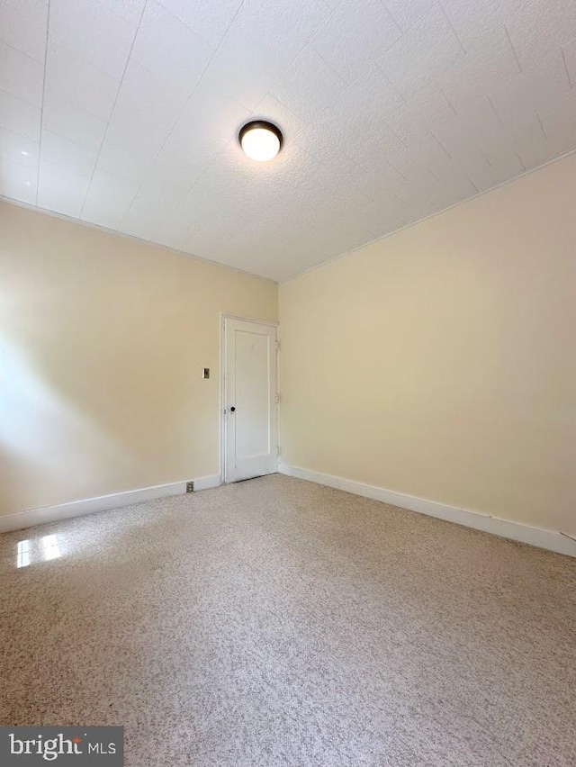 unfurnished room featuring carpet