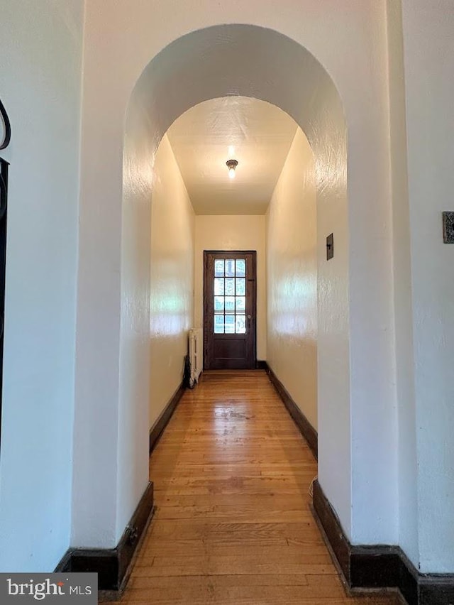 doorway to outside with wood-type flooring