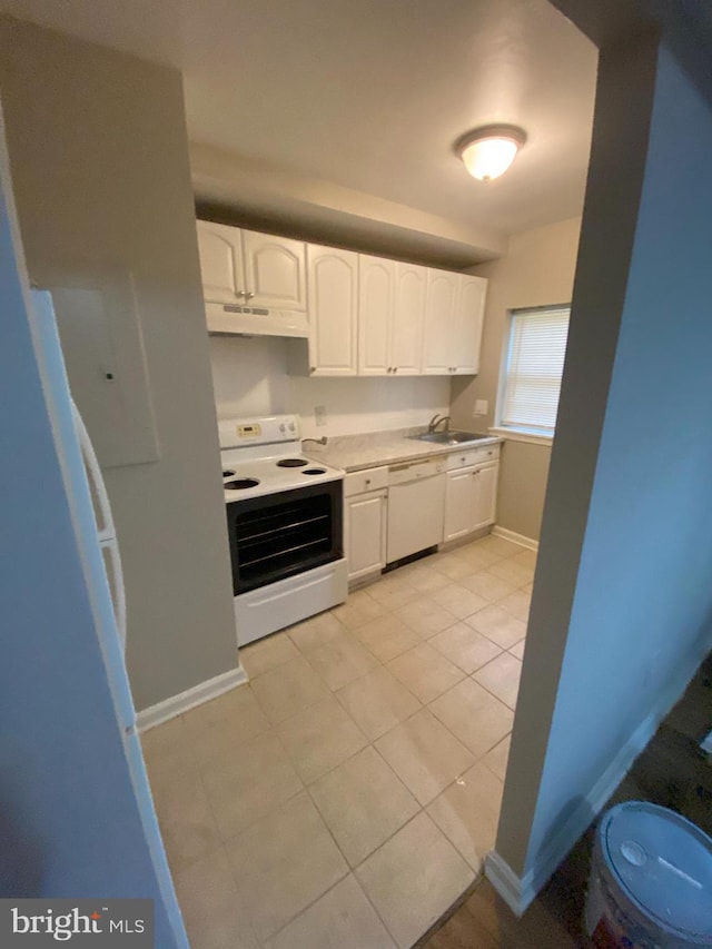 kitchen with white cabinets, light tile patterned floors, white appliances, and sink