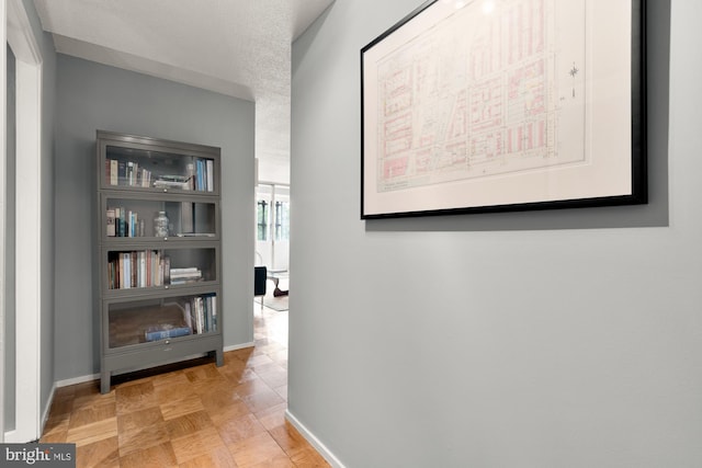 hallway featuring light parquet flooring