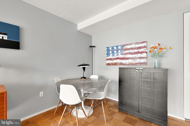 dining space with a textured ceiling