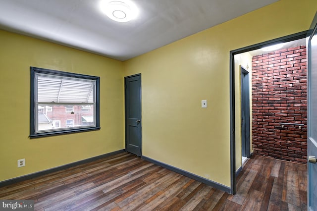 spare room featuring dark hardwood / wood-style floors