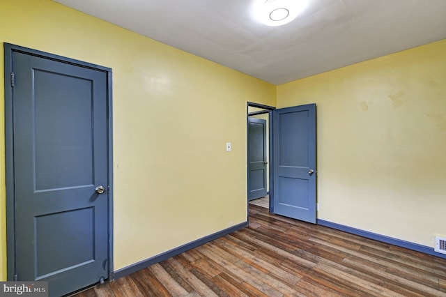 spare room with dark wood-type flooring