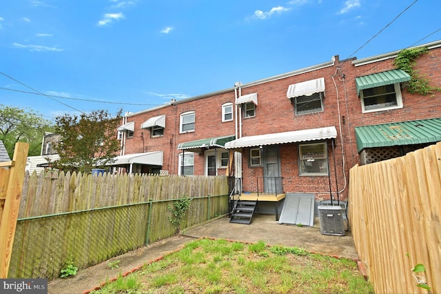 back of property featuring central AC unit