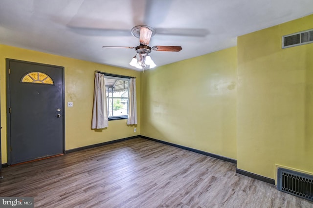 empty room with hardwood / wood-style floors and ceiling fan