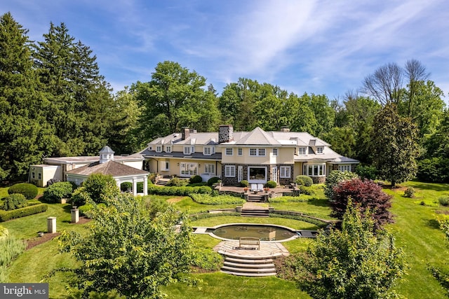 rear view of house with a lawn