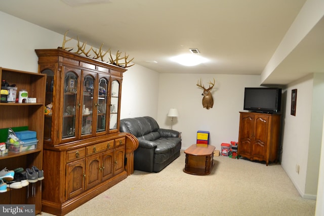 living area featuring carpet floors