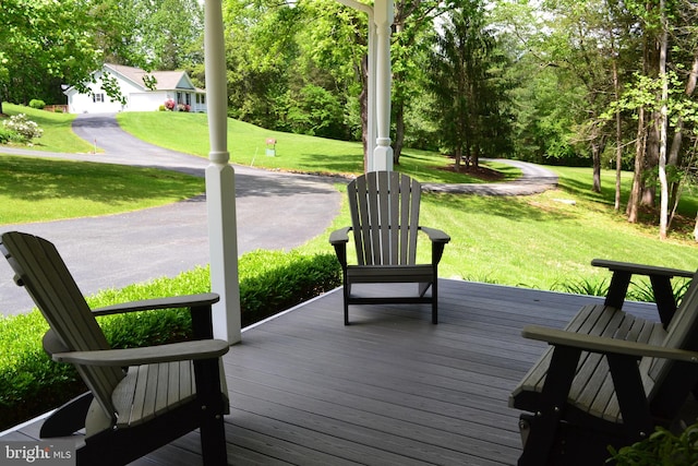 wooden terrace with a yard