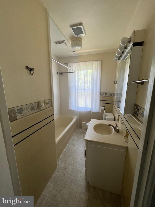 bathroom featuring tile floors and vanity with extensive cabinet space