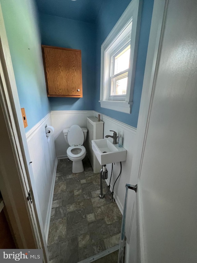 bathroom featuring tile flooring, sink, and toilet