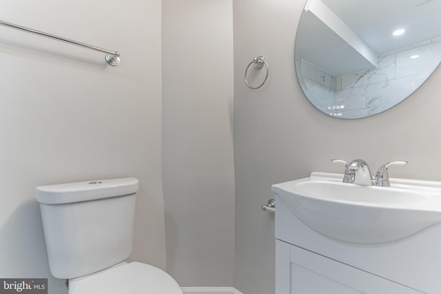 bathroom with vanity with extensive cabinet space and toilet