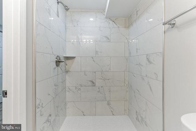 bathroom with tiled shower