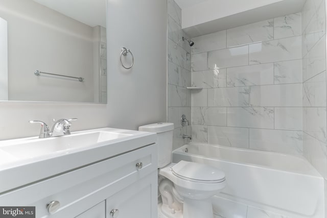 full bathroom with tile floors, tiled shower / bath, toilet, and vanity