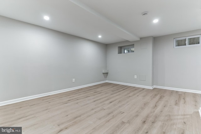 basement with light hardwood / wood-style flooring