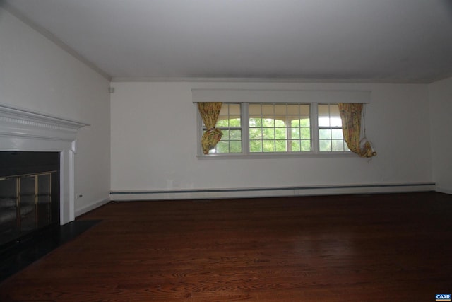 unfurnished living room with dark hardwood / wood-style floors and a baseboard heating unit