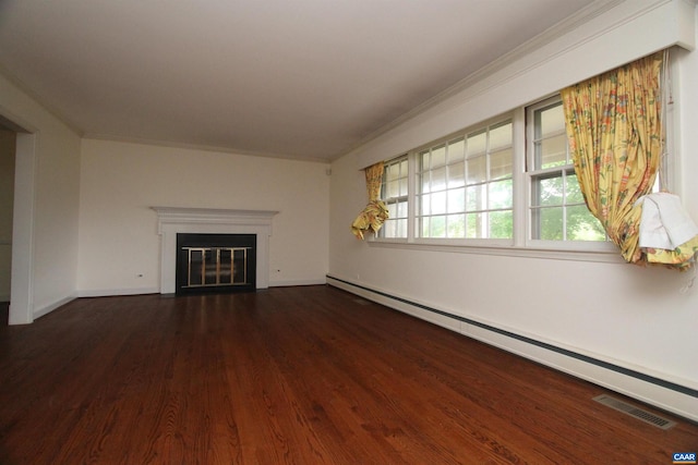 unfurnished living room with a baseboard heating unit, dark hardwood / wood-style flooring, and crown molding