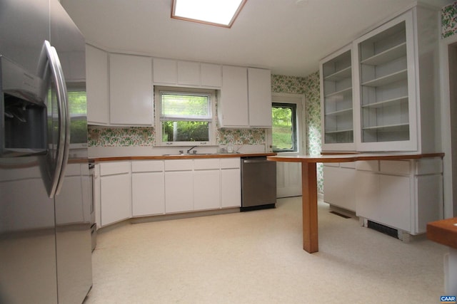 kitchen featuring white cabinetry, appliances with stainless steel finishes, and sink