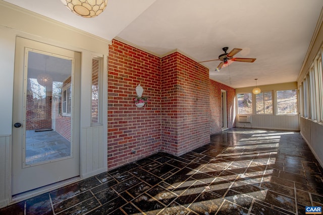 unfurnished sunroom featuring ceiling fan