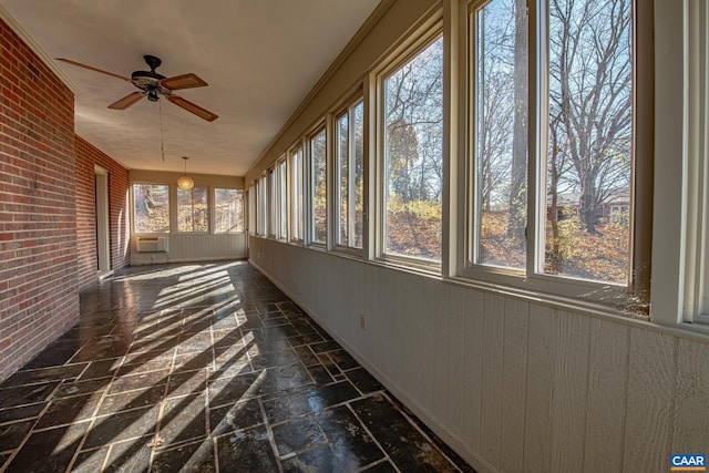 unfurnished sunroom with ceiling fan and a healthy amount of sunlight