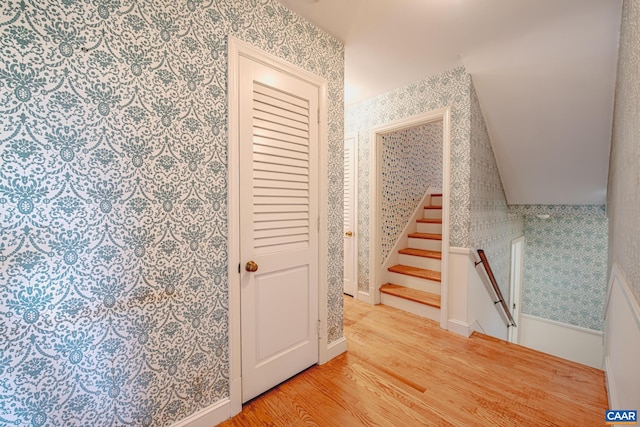 stairs featuring hardwood / wood-style floors