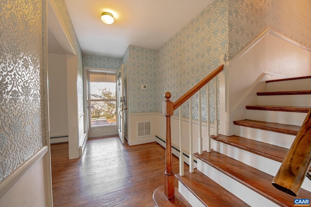 entrance foyer featuring wood-type flooring and a baseboard radiator