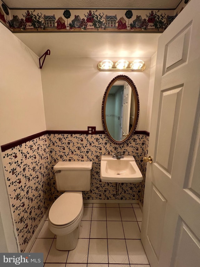 bathroom with tile floors, sink, and toilet