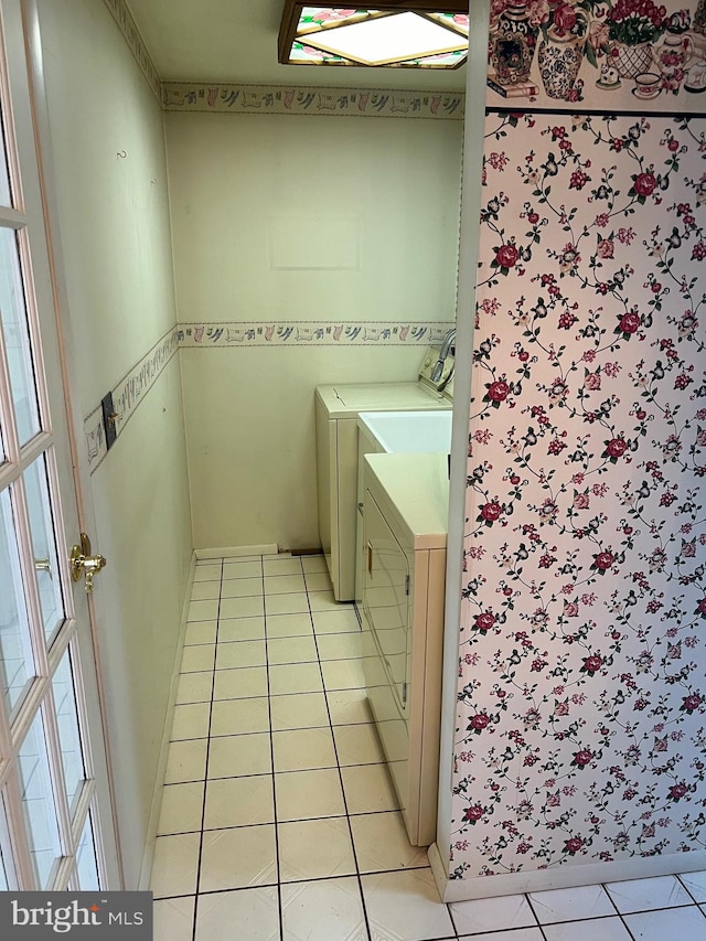 interior space featuring washer and dryer and light tile floors