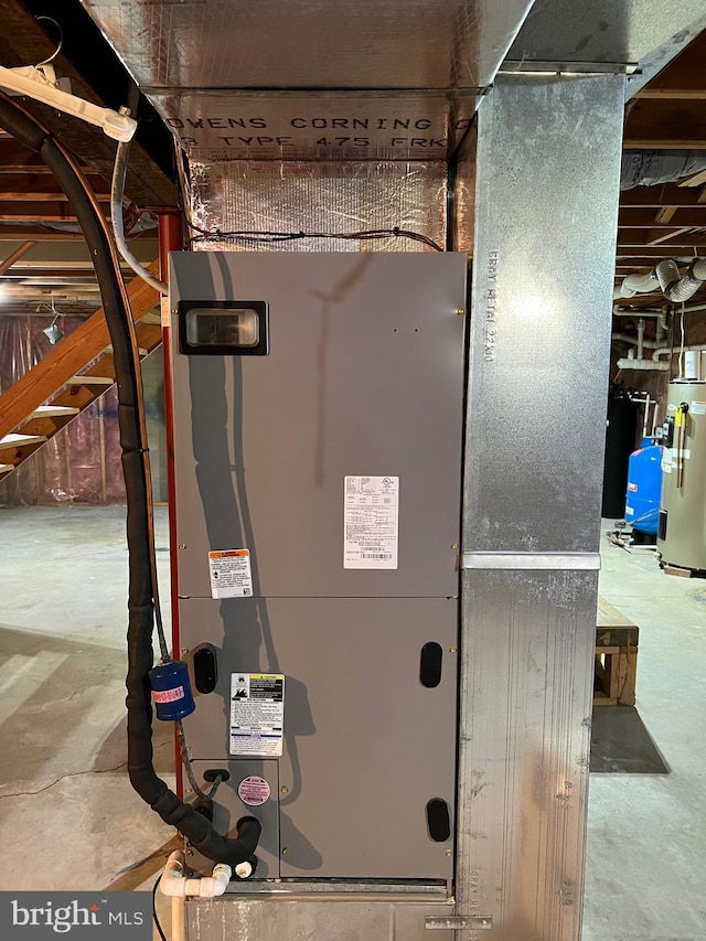 utility room featuring water heater and heating utilities