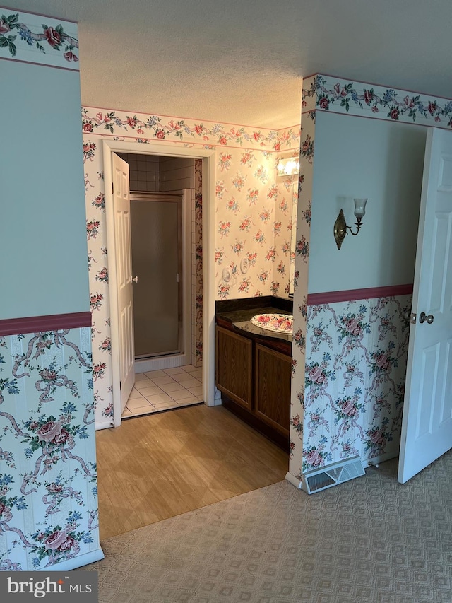 bathroom with tile flooring and a textured ceiling