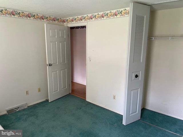 unfurnished bedroom with a closet and carpet floors