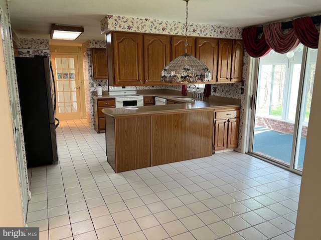 kitchen featuring light tile flooring, white electric range, kitchen peninsula, black fridge, and sink