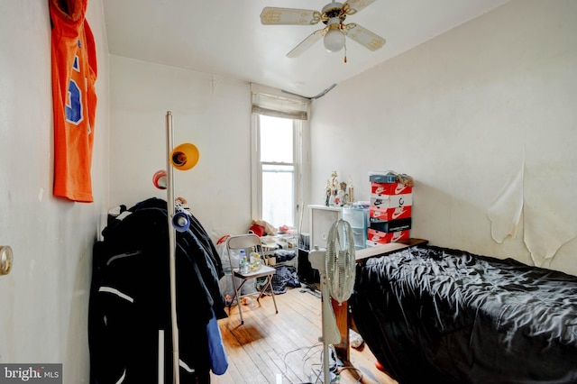 bedroom with ceiling fan, hardwood / wood-style flooring, and lofted ceiling