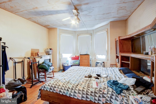 bedroom with ceiling fan and light hardwood / wood-style flooring